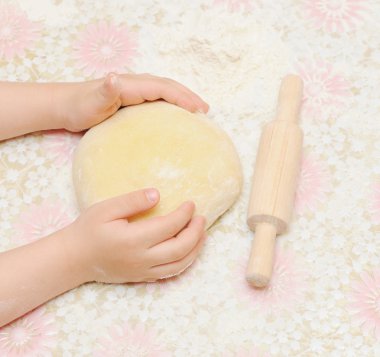 Child's hands kneading dough clipart