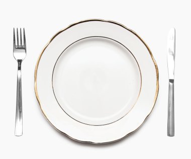 Knife, white plate and fork on a white background clipart