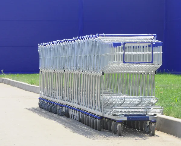 stock image Row of white shopping carts in front of a shopping center