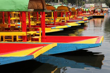 Colorful boats on canal clipart