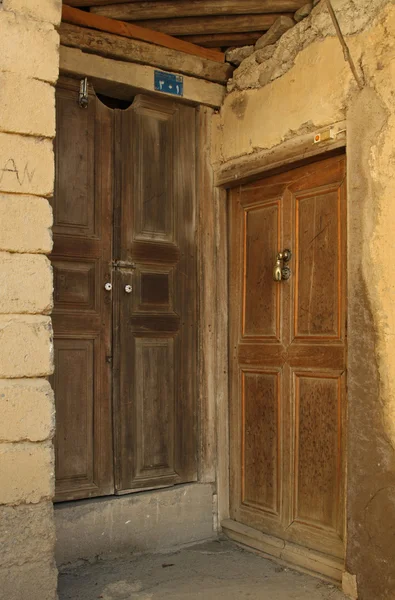 Wooden rural doors of two neighbors — Stock Photo, Image