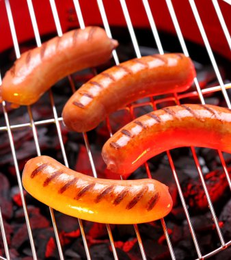 Hot sausages on barbecue clipart