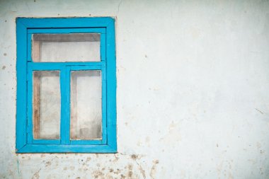 Old cracked wall with window painted with blue clipart