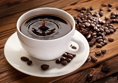 Drop falling into a cup of coffee. clipart