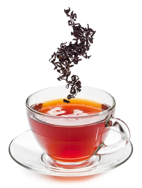 stock image Cup of tea and dry tea leaves.