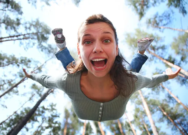 Woman falls from above the pine forest directly at you. — Stock Photo, Image