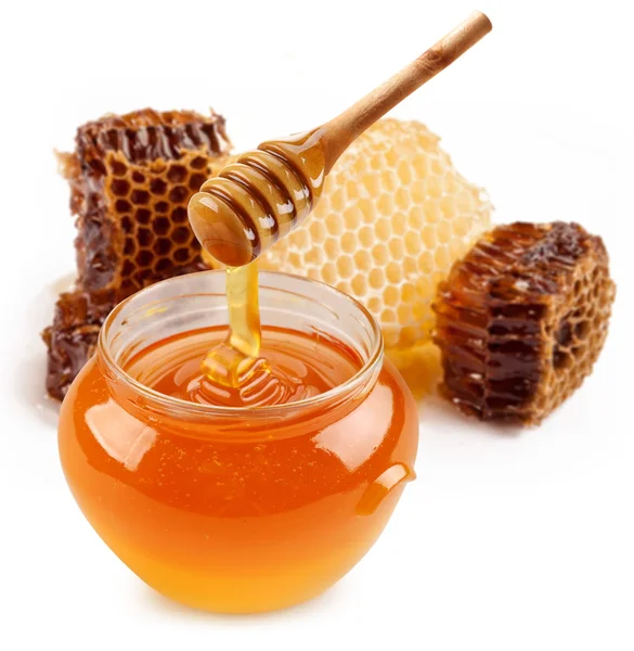 Pot met honing en houten stok. — Stockfoto