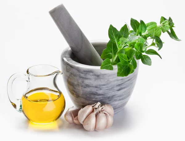 stock image Mortar with pestle and basil herbs and olive oil.