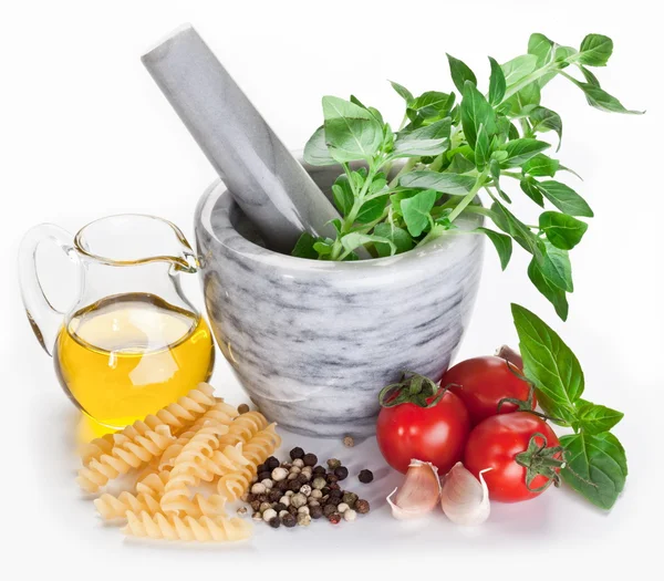 Mortar with pestle and basil herbs and olive oil. — Stock Photo, Image
