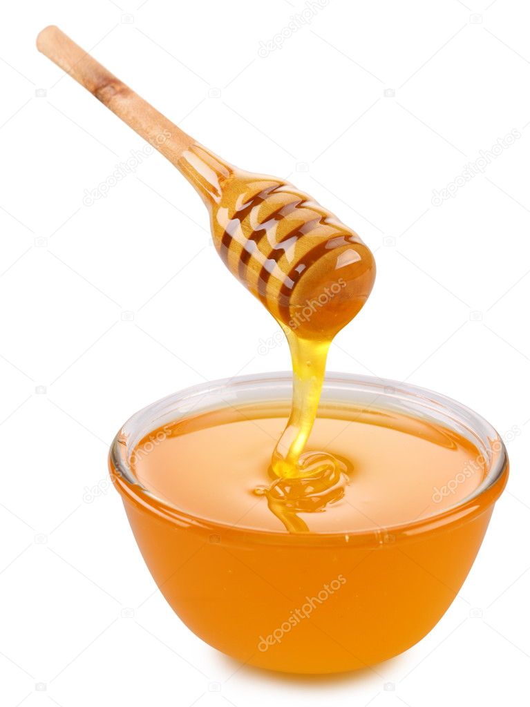 Bowl of honey and wooden stick.