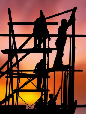 Construction workers against colorful sunset clipart