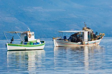 Two fishing boats in a southern Greece bay clipart