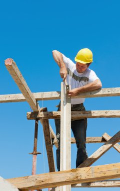 Construction worker on scaffold clipart