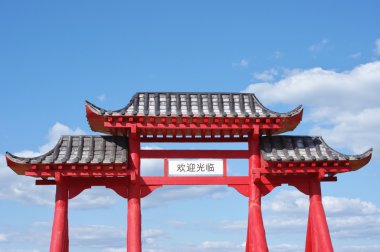 Gate of Buddhist temple and blue sky with clouds clipart