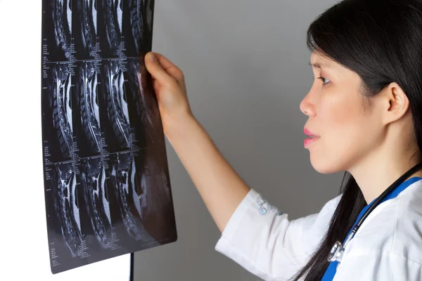 Attractive female Doctor viewing MRI exam — Stock Photo, Image