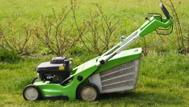 Lawn mower on fresh cut grass clipart