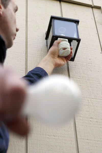 Installing a CFL — Stock Photo, Image