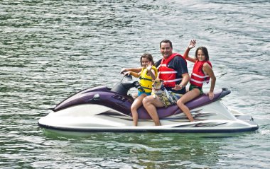 Man, Children and a Dog on Jet Ski clipart