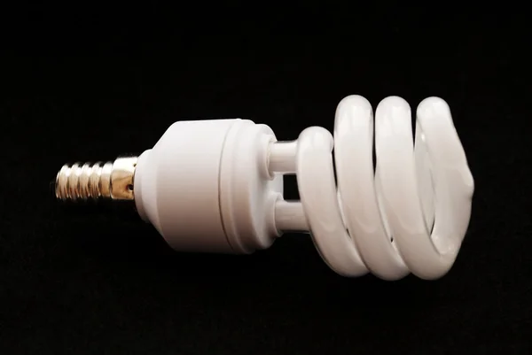 stock image Eltctric powersaving lightbulb at white background