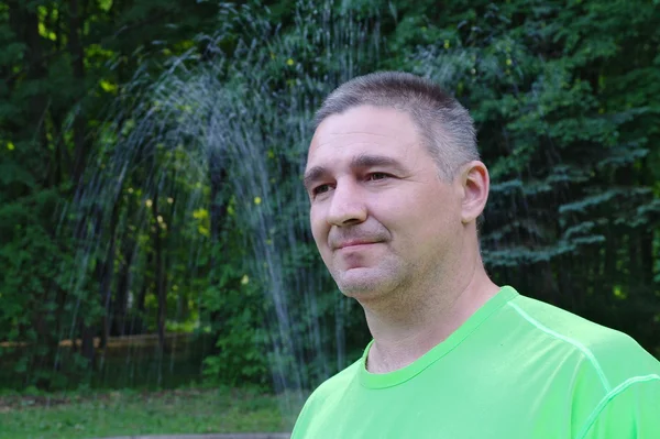 stock image Portrait of the man against a fountain