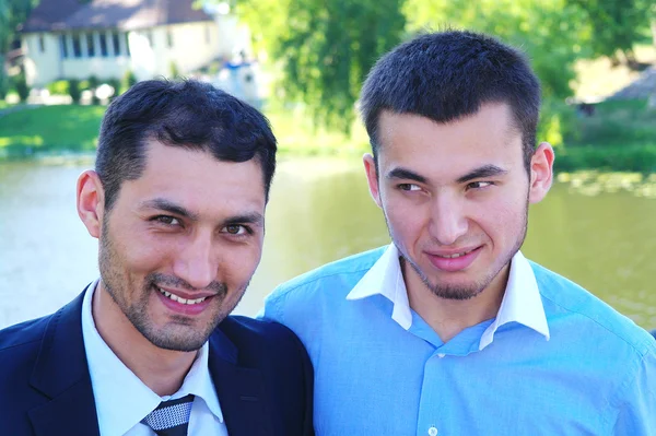 stock image Portrait of two young men on the background of the rivers