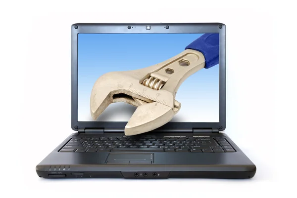 Laptop and wrench inside of monitor — Stock Photo, Image