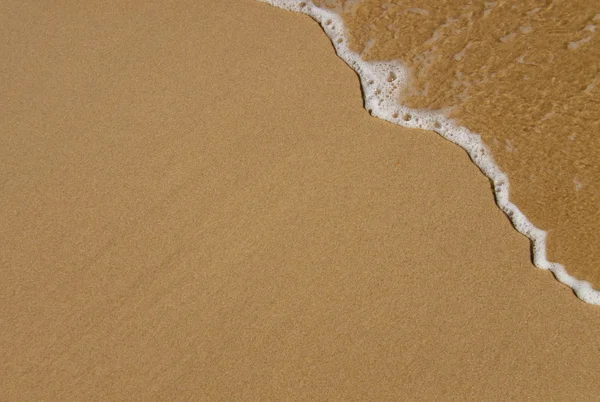 Welle über Sand — Stockfoto