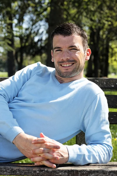 Happy man on a bench — Stock Photo, Image
