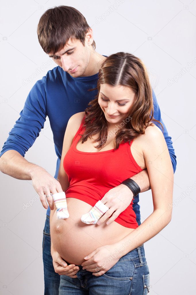 Man joking with pregnant wife's belly