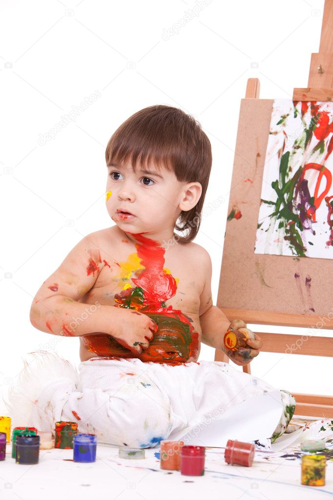 Funny child play with paints