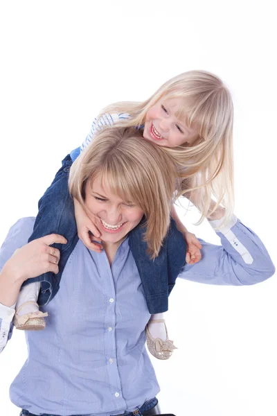 Smiling mom with child play on shoulders — Stock Photo, Image