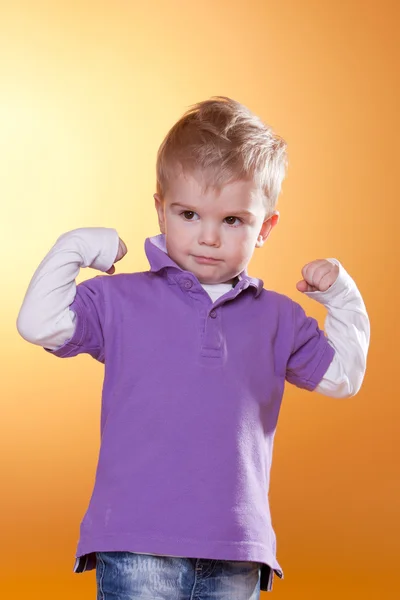 Strong little boy show muscles — Stock Photo, Image