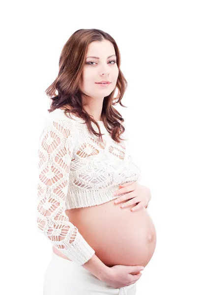 Беременная женщина держит живот рукой — стоковое фото