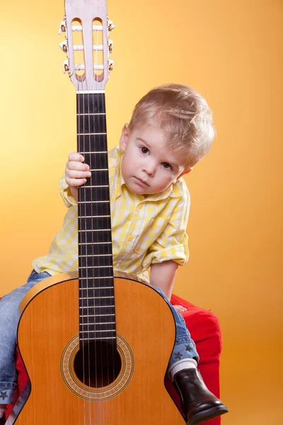 stock image Child proposing play the guitar