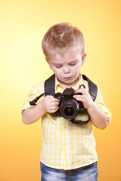 Little curious photographer watch photo on camera — Stock Photo, Image