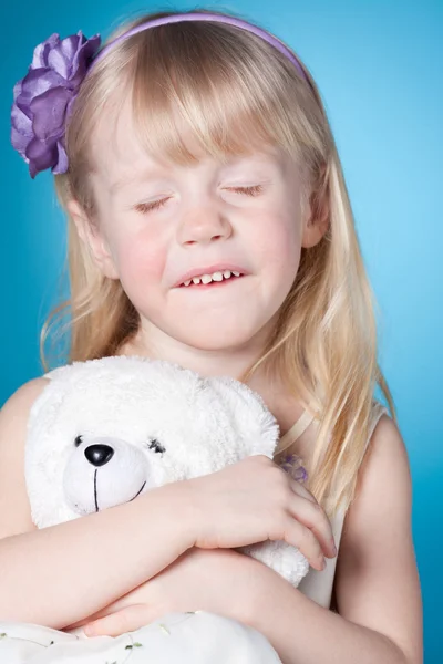 Happy dreamy little girl with toy — Stock Photo, Image