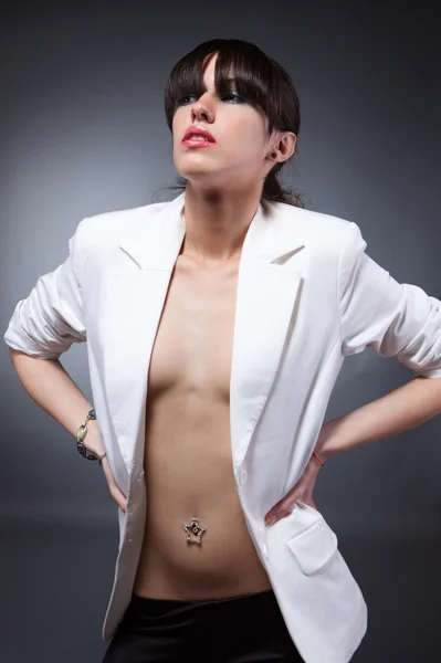 Beautiful sexy woman with piercing in white jacket — Stock Photo, Image