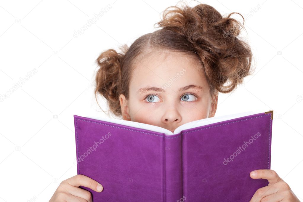 Curious girl peeping behind the book