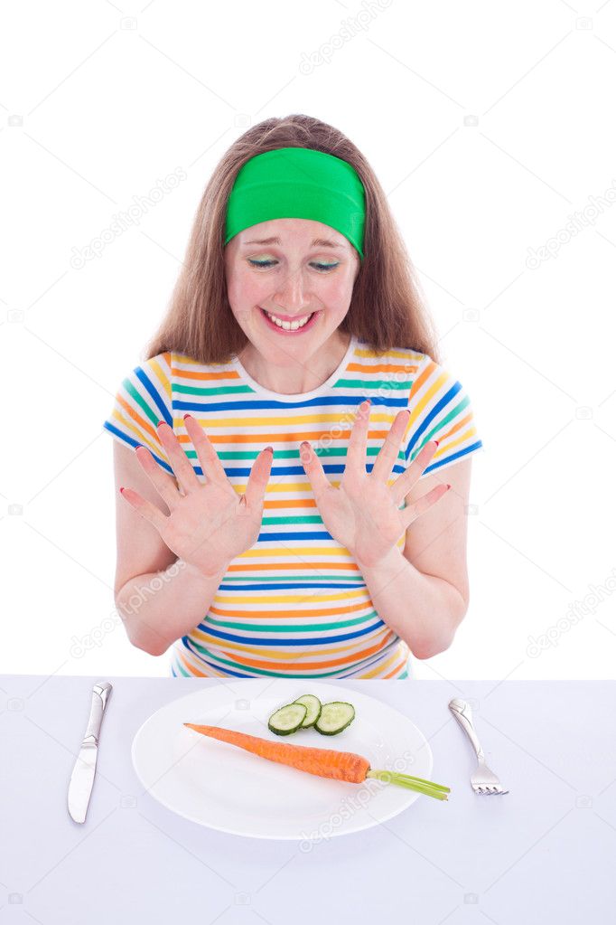 Young woman refuse to eat carrot and lettuce