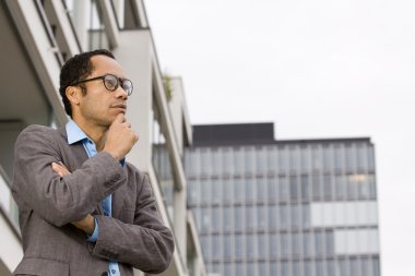 Smart casual business man portrait in front of office building clipart