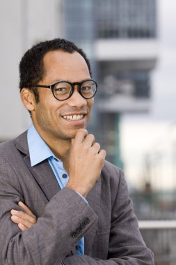 Smart casual business man portrait in front of office building clipart