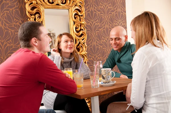 Vier met een praatje in een café — Stockfoto