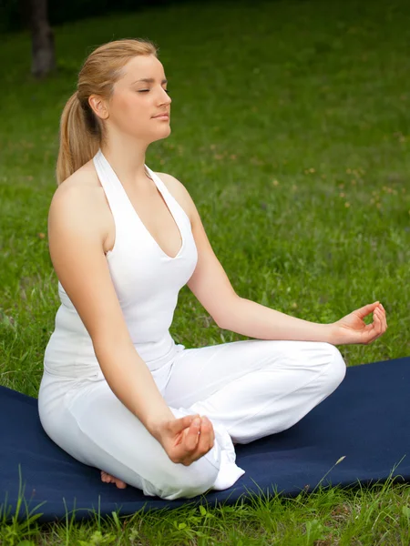 Meditatie in de natuur - schattig meisje mediteert buiten op een gr — Stockfoto