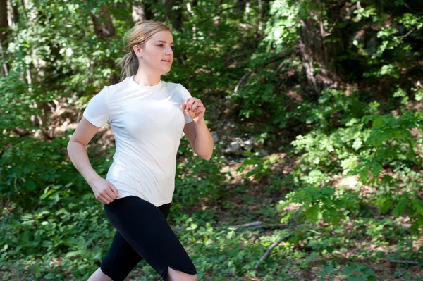 Attractive young woman on a run in nature — Stock Photo, Image