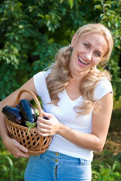 Young woman holding vegetables in the garden Stock Picture