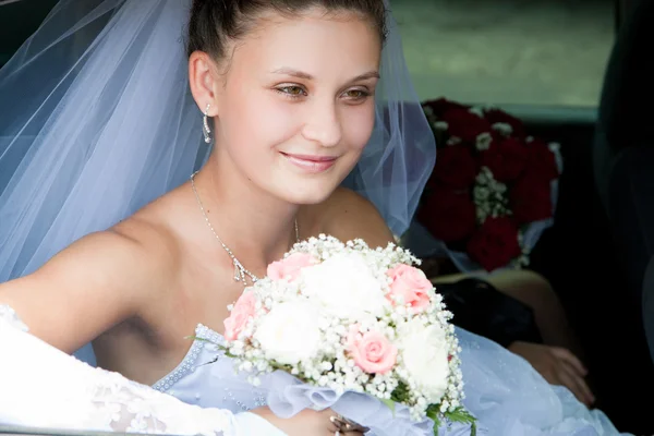 Bride looks out of the car — Stock Photo, Image