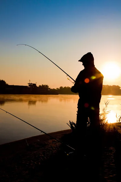 Silhouette of man fishing in a sunset Stock Photo by ©Pavel_Lysenko 6597211