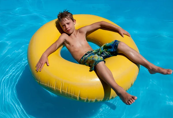 stock image Boy in the water on an inflatable ring