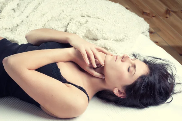 stock image woman lying on the snowy bed