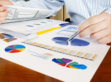 Analyzing investment charts. clipart